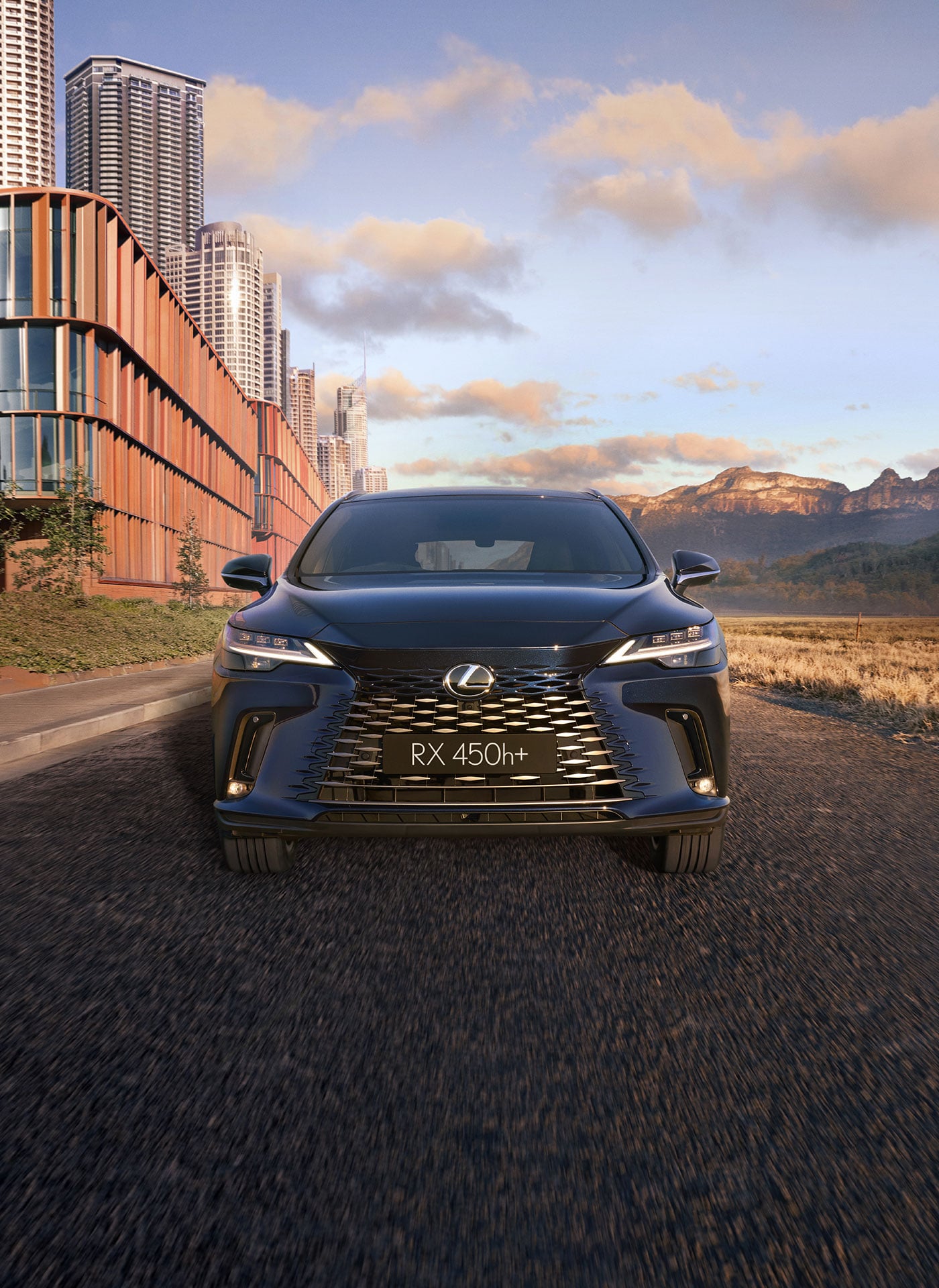 Lexus RX 450h+ driving with a scenic background